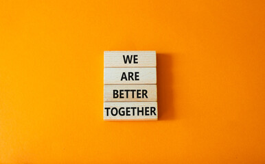 We are stronger better symbol. Wooden blocks with words We are better together. Beautiful orange background. We are stronger better concept. Copy space.