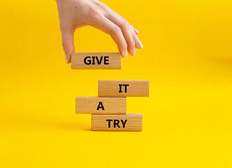 Give it a try symbol. Concept words Give it a try on wooden blocks. Beautiful yellow background....