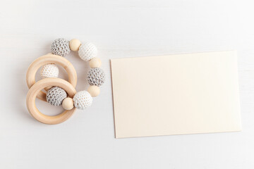Eco friendly organic newborn teethers and empty card mockup. Template for baby shower invitation,...