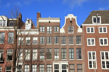 Fototapeta na wymiar Amsterdam Traditional Canal House Facades with Rope Hanging from a Hoist Beam, Netherlands