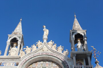 Venice beaches, gondolas, churches, St. Mark's City Square, the tower in the square, the church, the medieval and Roman artifacts, the canals in the city, the gondolas going on the canals and the sea,