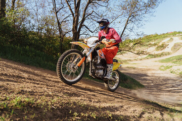Fototapeta na wymiar Man riding motorbike on motocross track.Extreme and Adrenaline. Motocross rider in action. Motocross sport. Active lifestyle