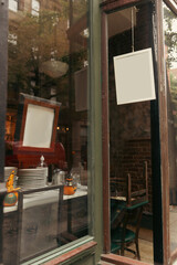 Empty signboards on showcase of shop on street in New York City.