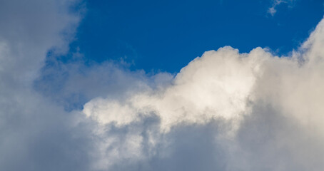 Beautiful huge fluffy clouds on the blue sky. Sky clouds background.