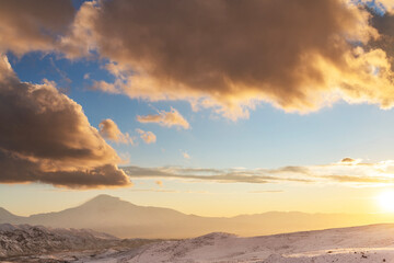 Fototapeta na wymiar Beautiful sunrise over the Ararat mountain. Armenia Winter landscape.