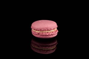 Colorful macaroon over black background