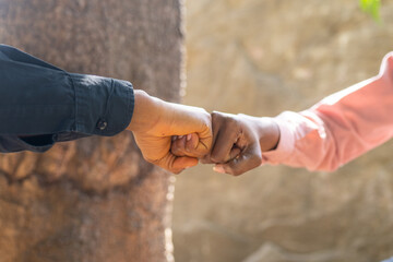 Two friends greet each other with a fist bump