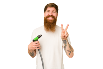 Adult man holding a watering hose isolated showing number two with fingers.