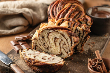Chocolate Babka or Brioche Bread. Homemade sweet yeast pastry chocolate swirl bread sliced on...