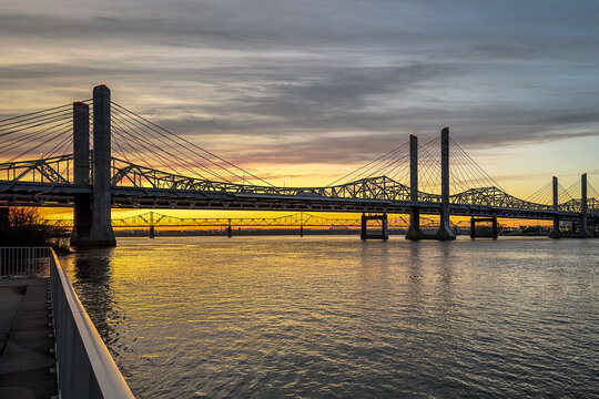 John F. Kennedy Bridge and Abraham Lincoln Bridge crossing the Ohio River between Louisville, Kentucky and Jeffersonville, Indiana at sunset.