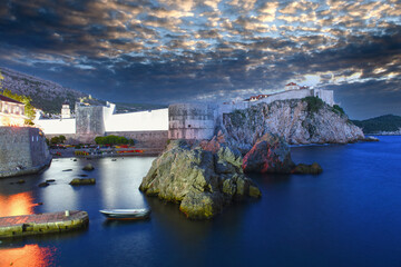 panoramic night view to the city skyline of Dubrovnik's Old City while sunset with dramatic sky, Croatia