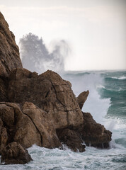 rough sea, waves of the ocean crashing into the rocks and splashing 