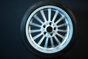 old car wheels titanium rims long exposure video on dark background spinning motion simulation