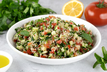 Levantine vegetarian salad with quinoa, tomatoes, cucumbers, parsley, lemon and dressing. Macro.