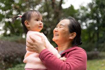 grandmother kiss her granddaughter in the park