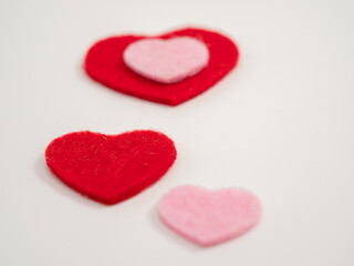 Hearts and a white flower on a white background. Valentine's Day.