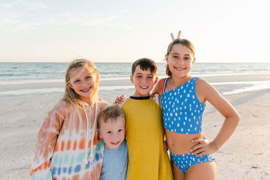 Cousins pose for portrait at the beach
