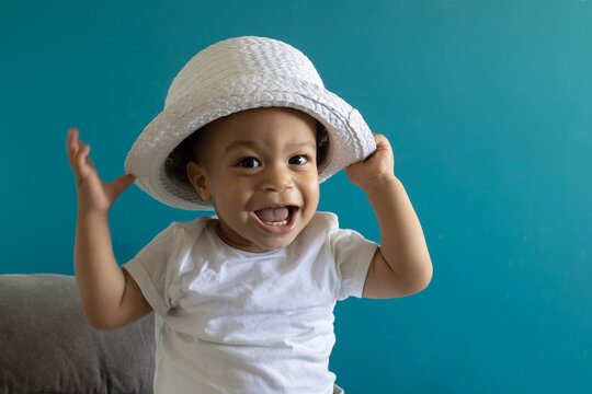 happy smiling one year old baby portrait in hat
