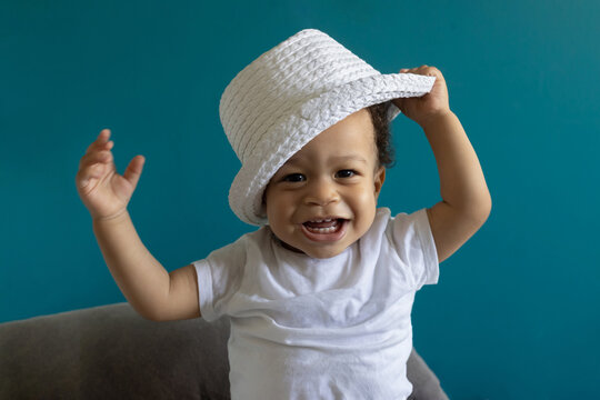 happy smiling one year old baby portrait in hat, fashion child boy