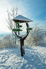 snow covered signpost in a winter landscape at the great horsel mountain