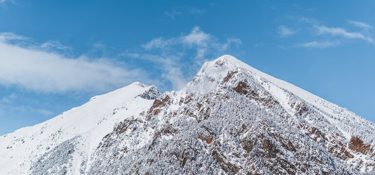 Panoramic view of snowy mountains. Abundance of snow that covers the entire mountain range. Sunny winter scenery. Tourism in Spain, Catalonia, Pyrenees, Ripoll&eacute;s, Vallter, Setcases, Gra de Fajol.