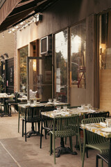 Tableware on tables of outdoor cafe on street in New York City.