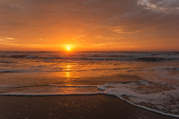 Fototapeta na wymiar Sea sunrise with beautiful cloudscape over the beach