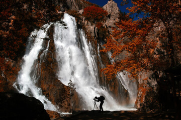 Nature photographer taking waterfall photos