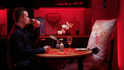 Man and anime waifu dakimakura having a romantic Valentine's dinner at home