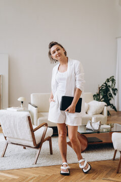 Stylish Mature Woman With Tablet In Living Room