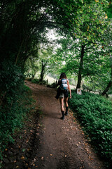woman hiking in the green forest happy and strong.