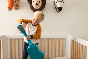 Boy tunes his guitar