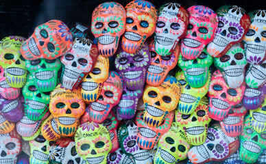 Small colorful smiling skulls with text written 