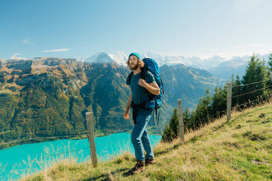Man hiking on trail on the background of Interlaken in Switzerland