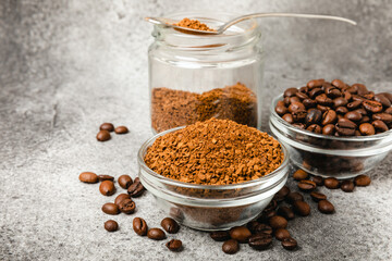 Coffee granules and coffee beans on a black textured background. Instant coffee drink. Energy hot drink. Place for text. Place for copy. Cheerful morning concept.