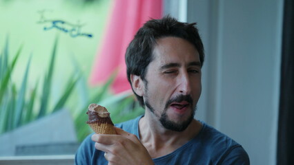Man blinking to camera while eating icecream person blinks