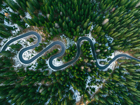 Aerial view of winding road in forest in winter