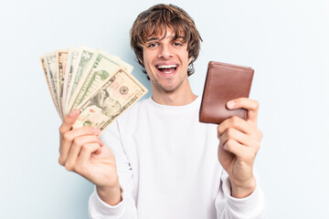 Young caucasian man holding wallet and banknotes isolated on blue background