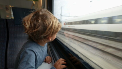 Kid travels by train going for vacation looking out window waving goodbye