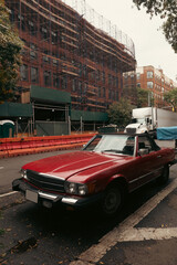 Vintage car on urban street in New York City.