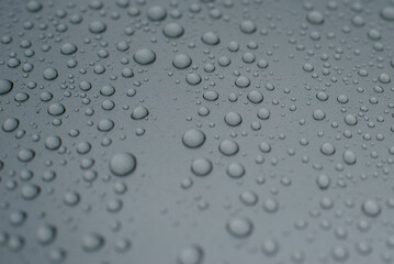 Drops of water on a gray background. Selective focus. Grey colour
