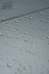 Drops of water on a gray background. Selective focus. Grey colour
