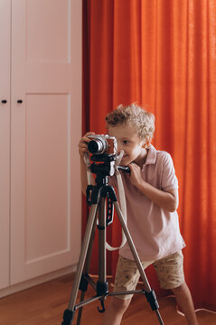 Boy taking photos at home