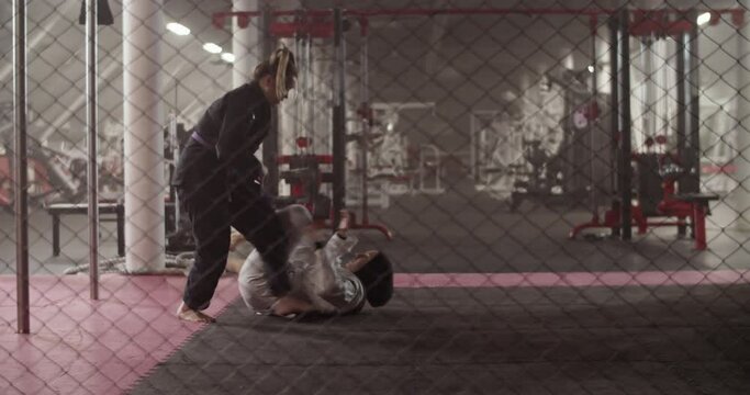 Female fighters practicing BJJ escape technique