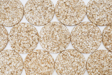 Background of round puffed rice cakes from above. Air crispy rice cakes with a minimum number of calories for a healthy lifestyle. Low calorie diet food. Free space for text