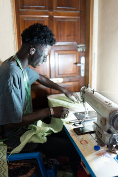 male dressmaker using sewing machine