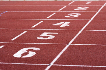 Red running racetrack finishing line with numbers 1-6. Landscape or horizontal photo.