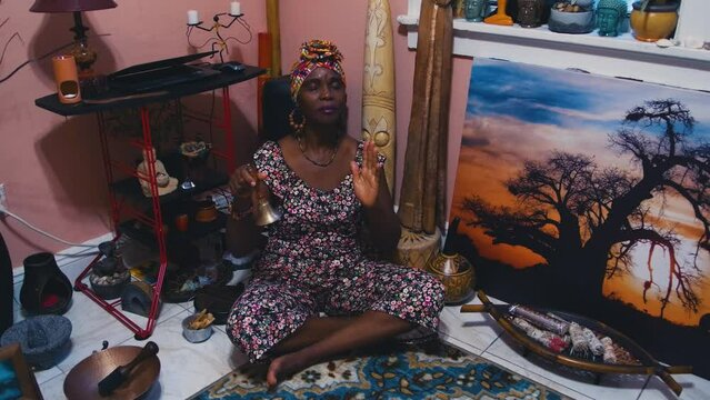 Black Stock Footage of calm, meditative, and spiritual elderly Black senior woman in her holistic and zen home filled with African art