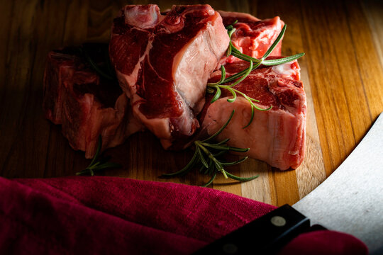 Thick-cut lamb chops with fresh rosemary ready for the grill or broiler.