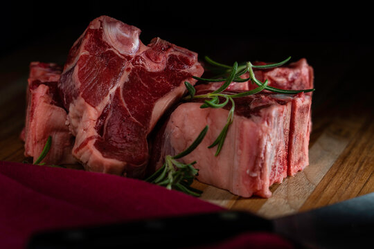 Thick-cut lamb chops with fresh rosemary ready for the grill or broiler.